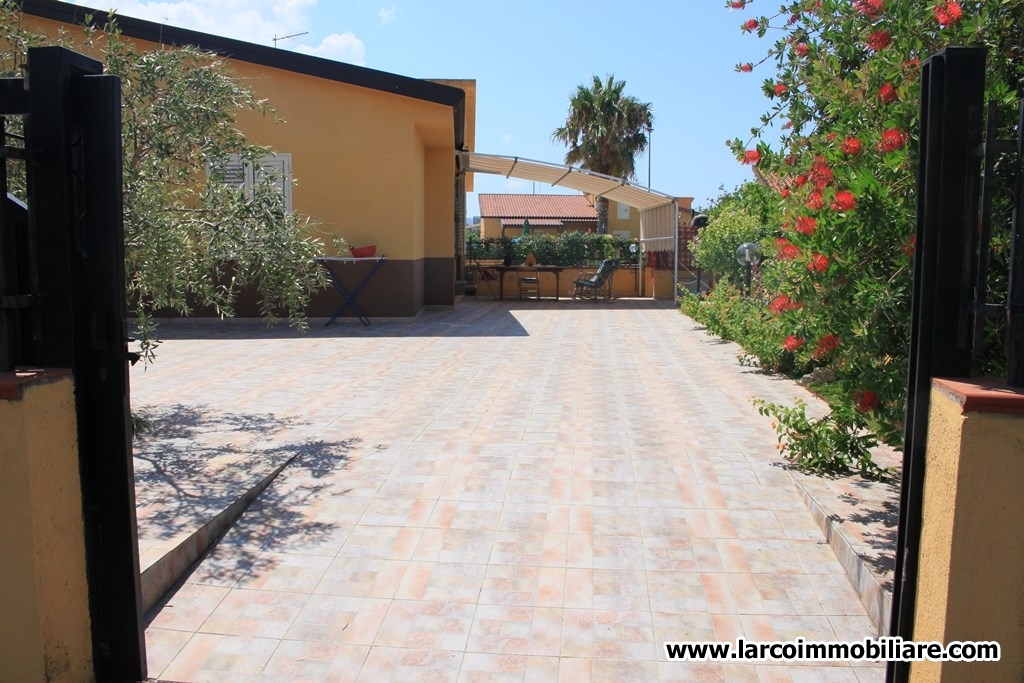 Four family house with large paved courtyard