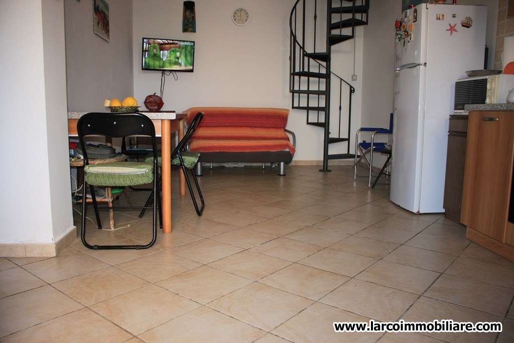 Four family house with large paved courtyard