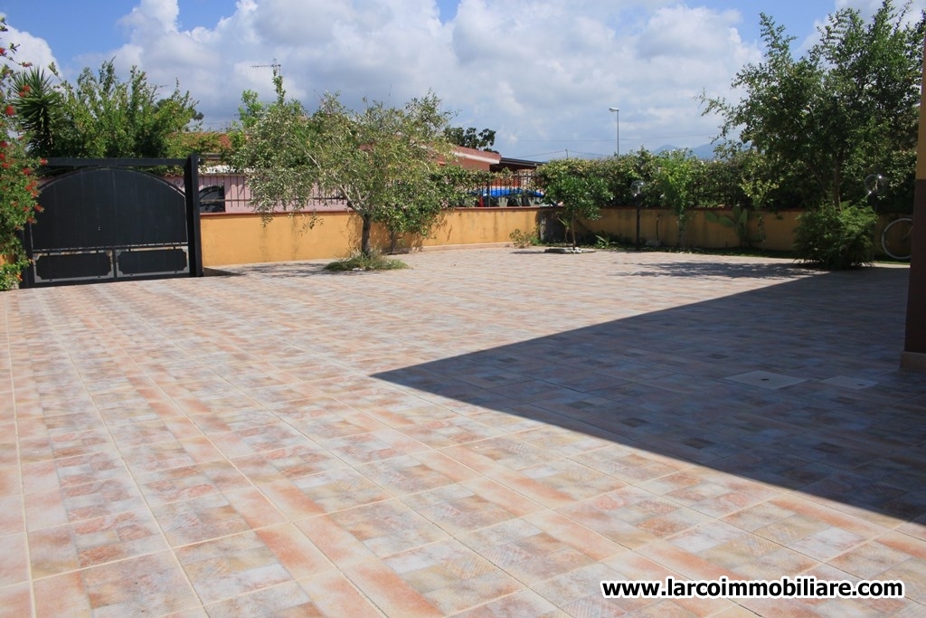 Four family house with large paved courtyard