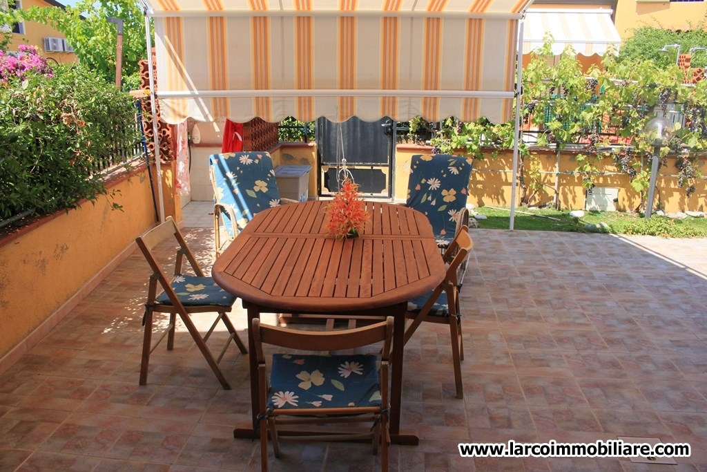 Four family house with large paved courtyard